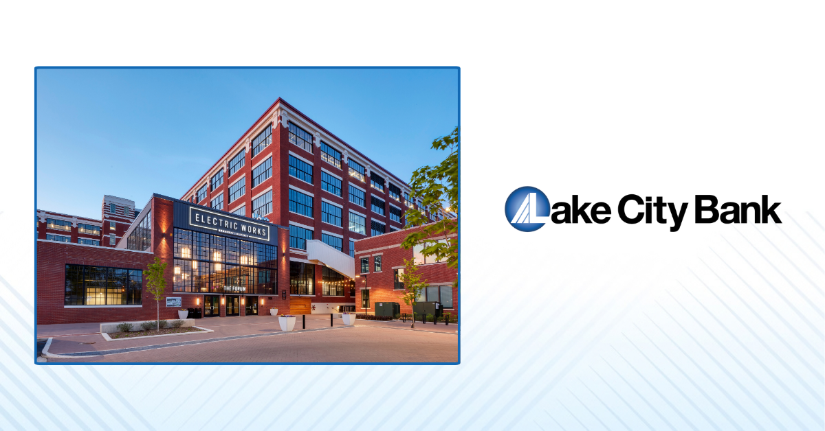 Lake City Bank logo displayed beside a photo of the Electric Works campus, a red brick mixed-use development building.