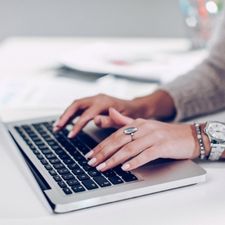 Laptop with keyboard and hands