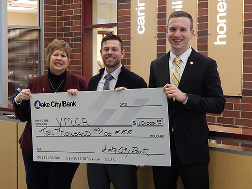 Photo of Lake City Bank employees giving check to YMCA